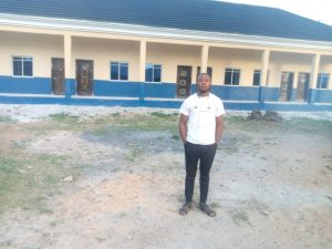 Zacks standing in the classroom block built in 2020